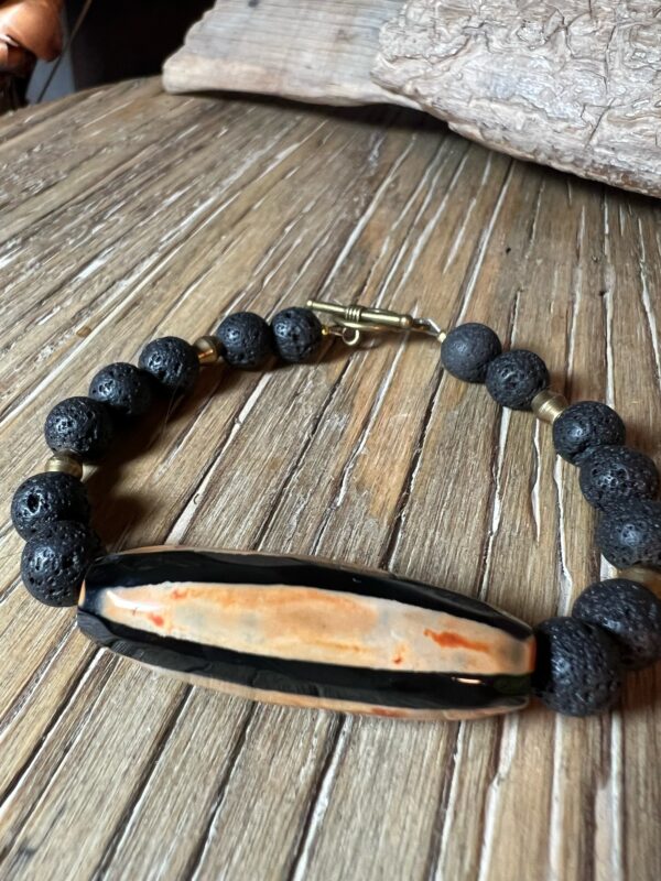 Black-and-Orange--gate-with-Lava-Rock-and-Brass-Bracelet